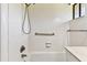 An all-white tub and shower combination with white tiled walls at 880 S Village Lake N Dr # 106, St Petersburg, FL 33716