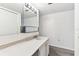 A bathroom with a marble-like vanity and cabinet under the sink at 880 S Village Lake N Dr # 106, St Petersburg, FL 33716