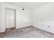 An empty bedroom with a closet and neutral carpet at 880 S Village Lake N Dr # 106, St Petersburg, FL 33716