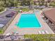 An inviting community pool is complemented by lounge chairs and tables, creating an ideal place to relax and soak up the sun at 880 S Village Lake N Dr # 106, St Petersburg, FL 33716