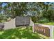 The Village Lake Condominiums community sign is set against a backdrop of mature trees and lush landscaping at 880 S Village Lake N Dr # 106, St Petersburg, FL 33716