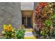 Exterior view of the home's entrance with vibrant landscaping and visible unit number at 880 S Village Lake N Dr # 106, St Petersburg, FL 33716
