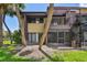 Exterior view of a two-story residence featuring a screened patio and a spiral staircase at 880 S Village Lake N Dr # 106, St Petersburg, FL 33716