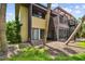 View of the rear exterior with a screened patio and spiral staircase at 880 S Village Lake N Dr # 106, St Petersburg, FL 33716