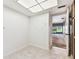 Open kitchen area with tile floors leads to the hallway, a bright and functional space at 880 S Village Lake N Dr # 106, St Petersburg, FL 33716