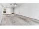 Spacious living room features neutral carpeting and a ceiling fan at 880 S Village Lake N Dr # 106, St Petersburg, FL 33716