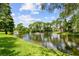Scenic view of the pond featuring a fountain and beautiful landscaping within Village Lake Condominiums at 880 S Village Lake N Dr # 106, St Petersburg, FL 33716
