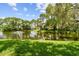 Relaxing pond view featuring a fountain and lush greenery at Village Lake Condominiums at 880 S Village Lake N Dr # 106, St Petersburg, FL 33716