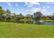 A serene view of the pond with a fountain and lush green surroundings in Village Lake Condominiums at 880 S Village Lake N Dr # 106, St Petersburg, FL 33716