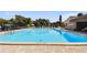 A beautiful community pool with a brick paved deck under a sunny sky at 880 S Village Lake N Dr # 106, St Petersburg, FL 33716