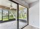 View from carpeted bedroom to enclosed, tiled porch with view to water at 880 S Village Lake N Dr # 106, St Petersburg, FL 33716