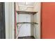 Inside the closet, wooden shelves are installed for ample storage space to maximize organization at 880 S Village Lake N Dr # 106, St Petersburg, FL 33716