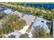 Aerial view of homes with backyard pools in a lush, well-maintained community near a scenic lake and green spaces at 10240 Shadow Branch Dr, Tampa, FL 33647