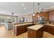 Open-concept kitchen featuring wood cabinetry, an island, and seamless integration with the living area at 10240 Shadow Branch Dr, Tampa, FL 33647