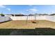Fenced backyard featuring a swing set and ample space at 11210 Kelly Green Ave, Wimauma, FL 33598
