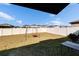 Backyard featuring a swing set, white fence and grassy area at 11210 Kelly Green Ave, Wimauma, FL 33598