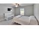 Calm bedroom with bed, crib, and window providing natural light and backyard views at 11210 Kelly Green Ave, Wimauma, FL 33598