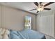 Comfortable bedroom with a queen bed, ceiling fan and a window providing natural light at 11210 Kelly Green Ave, Wimauma, FL 33598