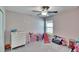 Bright bedroom featuring a ceiling fan, plush carpet, and a cozy play area at 11210 Kelly Green Ave, Wimauma, FL 33598