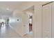 Long hallway with tile floors and white walls leading to other rooms at 11210 Kelly Green Ave, Wimauma, FL 33598