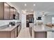 Modern kitchen featuring stainless steel appliances, dark wood cabinets, and granite countertops at 11210 Kelly Green Ave, Wimauma, FL 33598