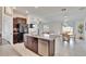 Open-concept kitchen and living area with stainless steel appliances and island seating at 11210 Kelly Green Ave, Wimauma, FL 33598
