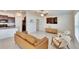 Bright living room with modern furniture, a ceiling fan, and an open layout at 11210 Kelly Green Ave, Wimauma, FL 33598
