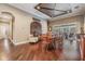 Open dining room with wine theme, custom ceiling, and access to outdoor living at 19116 Sweet Clover Ln, Tampa, FL 33647