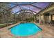 Inviting pool area with a screened enclosure, waterfall spa, and ample space for outdoor enjoyment at 19116 Sweet Clover Ln, Tampa, FL 33647