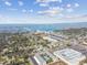 Expansive aerial view showcases the neighborhood, bridge, and stunning waterfront, blending urban and natural elements at 215 Valencia Blvd # 106, Belleair Bluffs, FL 33770