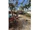 Landscaped backyard featuring a pool and outdoor kitchen with a tiki hut at 2450 Roberta Ln, Clearwater, FL 33764