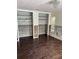 Bedroom featuring dark wood floors, closets, and repair areas on the walls at 2450 Roberta Ln, Clearwater, FL 33764