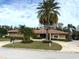 Well-maintained single-story home showcasing a circular driveway and mature landscaping at 2450 Roberta Ln, Clearwater, FL 33764