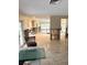 Partially renovated living room featuring tile flooring and natural light at 2450 Roberta Ln, Clearwater, FL 33764