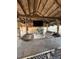 Tiki hut featuring an outdoor kitchen with a stone countertop, grill, and barstool seating at 2450 Roberta Ln, Clearwater, FL 33764