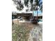 Landscaped backyard featuring a pool and tiki hut with seating at 2450 Roberta Ln, Clearwater, FL 33764
