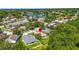 Aerial view of neighborhood with red pin showing property location near a lake and lush greenery at 4251 Whittner Dr, Land O Lakes, FL 34639