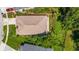 Aerial view of a single-Gathering home with mature trees, a well-maintained roof, and a driveway at 4251 Whittner Dr, Land O Lakes, FL 34639