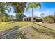 Expansive backyard with lush lawn, bordered by mature trees, enhancing privacy of the property at 4251 Whittner Dr, Land O Lakes, FL 34639