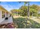 A spacious backyard surrounded by mature trees, offering plenty of space for outdoor activities at 4251 Whittner Dr, Land O Lakes, FL 34639