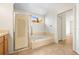 Clean bathroom featuring a shower, garden tub, and closet for storage at 4251 Whittner Dr, Land O Lakes, FL 34639