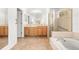 Bright Primary bathroom featuring double vanity, soaking tub, and walk-in shower at 4251 Whittner Dr, Land O Lakes, FL 34639
