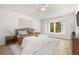 Cozy bedroom with light-colored walls, a large window, and a ceiling fan at 4251 Whittner Dr, Land O Lakes, FL 34639
