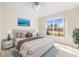 Bright bedroom featuring a plush bed, tile floors, a large window, and ample natural light at 4251 Whittner Dr, Land O Lakes, FL 34639
