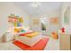 Bright bedroom features colorful decor, playful accents, and plenty of natural light at 4251 Whittner Dr, Land O Lakes, FL 34639