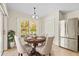 Bright dining area features tile flooring, a modern light fixture, and a view of the backyard at 4251 Whittner Dr, Land O Lakes, FL 34639