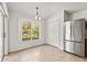 Dining area featuring stainless steel fridge, sliding door to patio and closet at 4251 Whittner Dr, Land O Lakes, FL 34639
