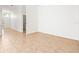A large, empty room featuring tile floors and neutral colored walls near the front of the house at 4251 Whittner Dr, Land O Lakes, FL 34639