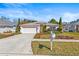 Charming single-story home with a well-manicured lawn and attached two-car garage at 4251 Whittner Dr, Land O Lakes, FL 34639