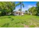 Charming single story home with lush green lawn and mature trees enhancing curb appeal at 4251 Whittner Dr, Land O Lakes, FL 34639
